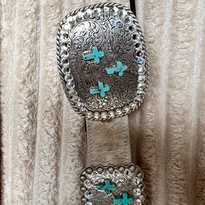 Silver and Turquoise Western Belt on cow hide .